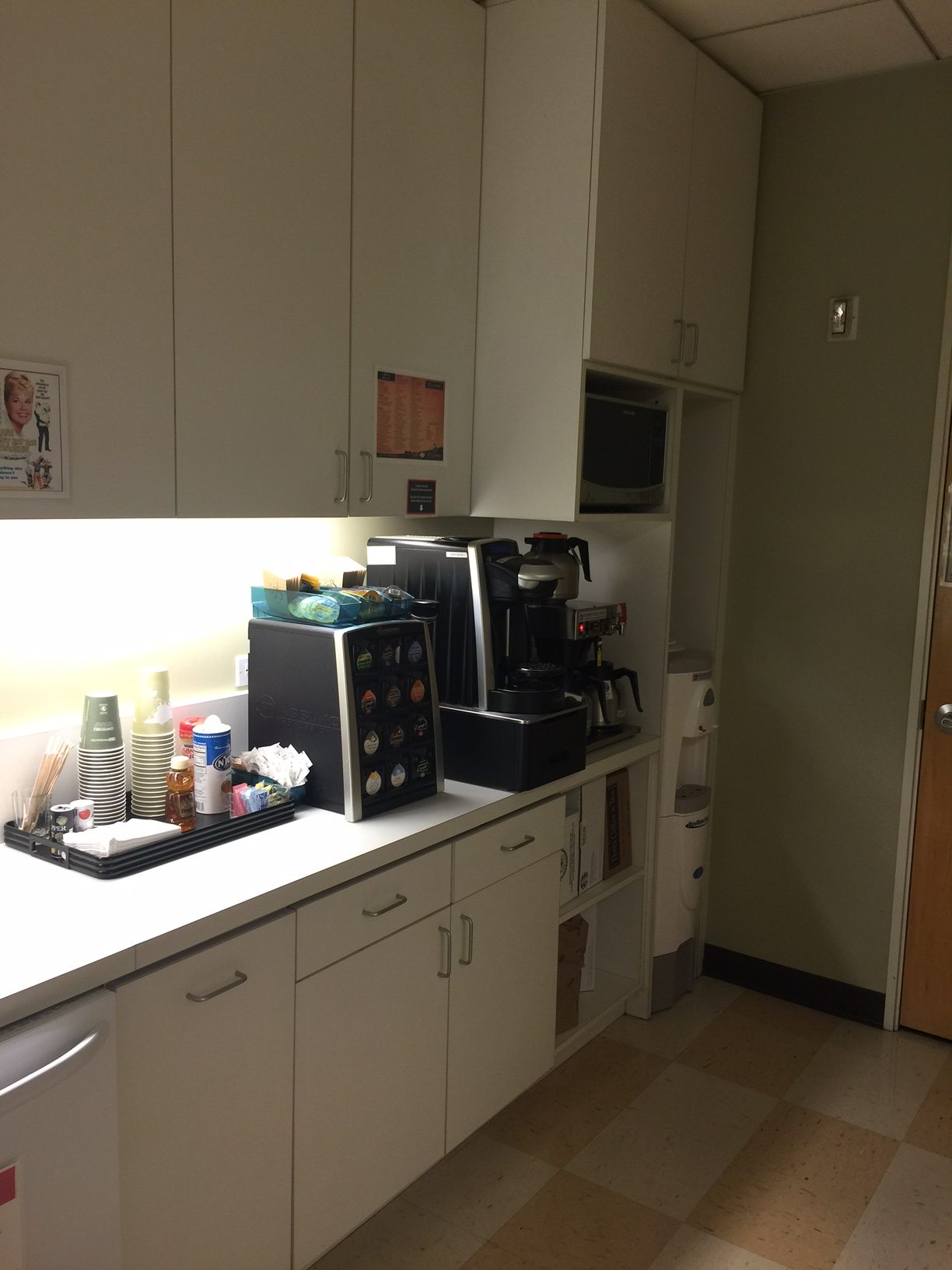 Installed breakroom cabinetry and counter — image 1